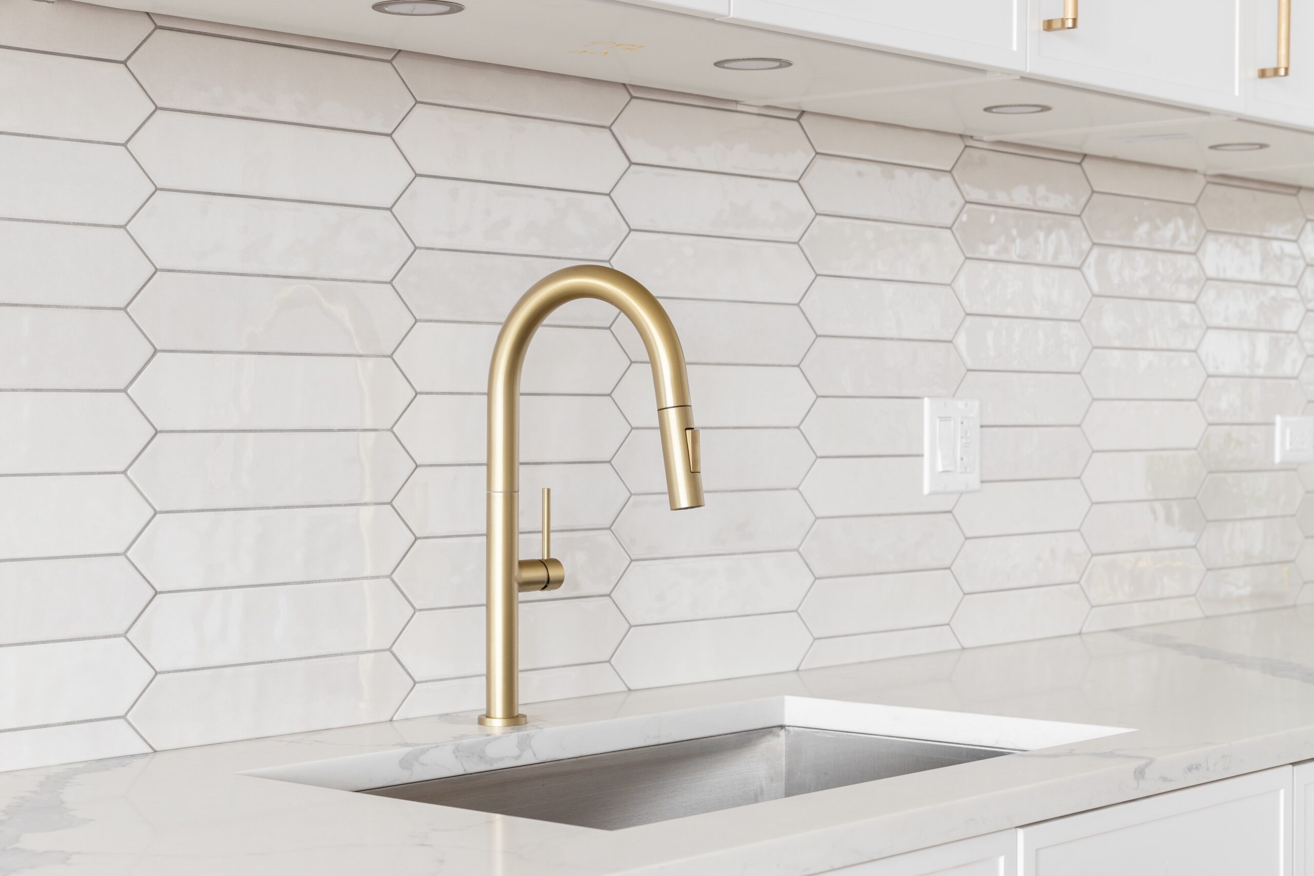 A,Beautiful,Kitchen,Faucet,Detail,With,White,Cabinets,,A,Gold